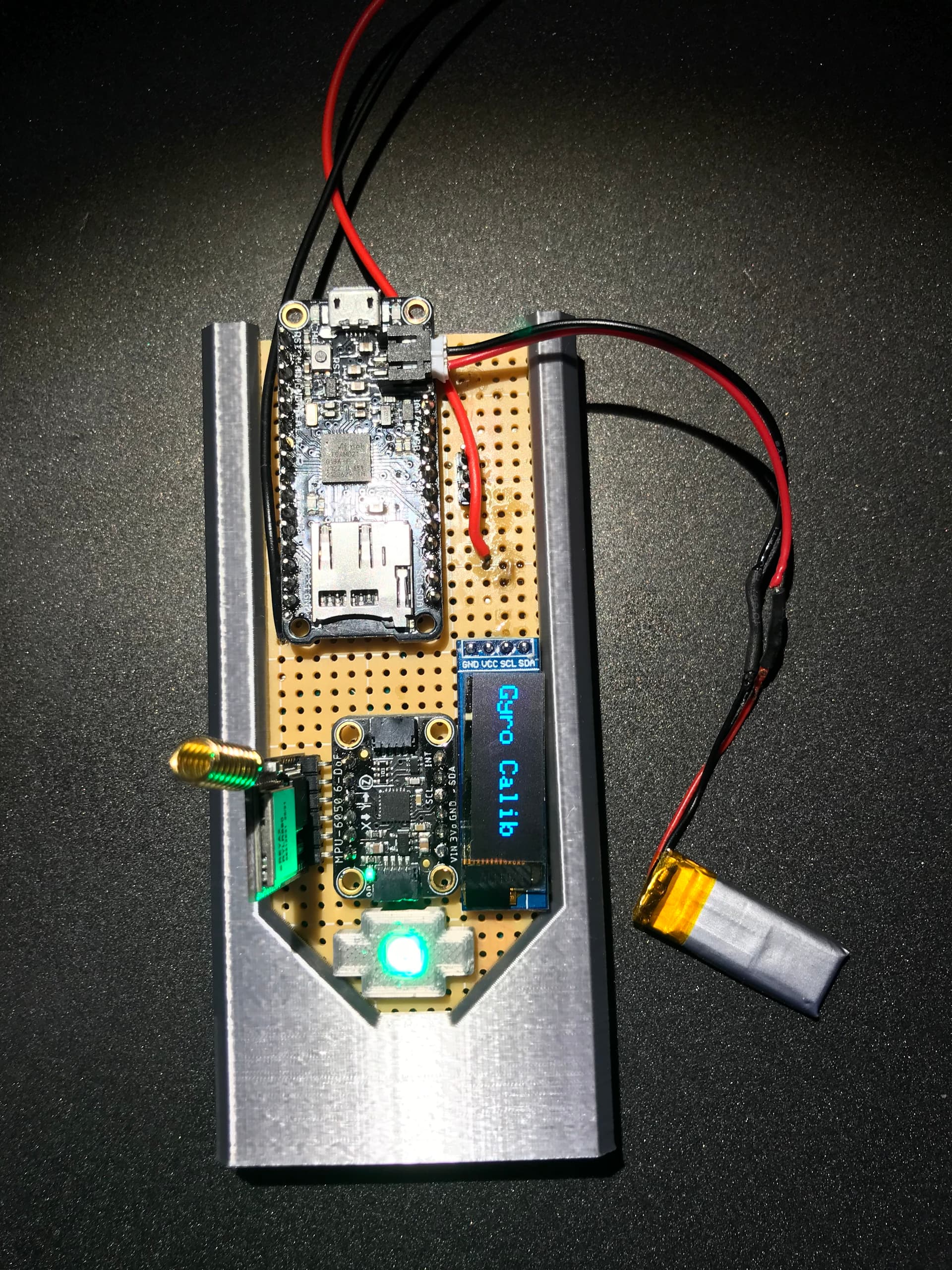 Hand-soldered FC2 flight computer showing Feather M0, sensors, LoRa radio, and OLED display