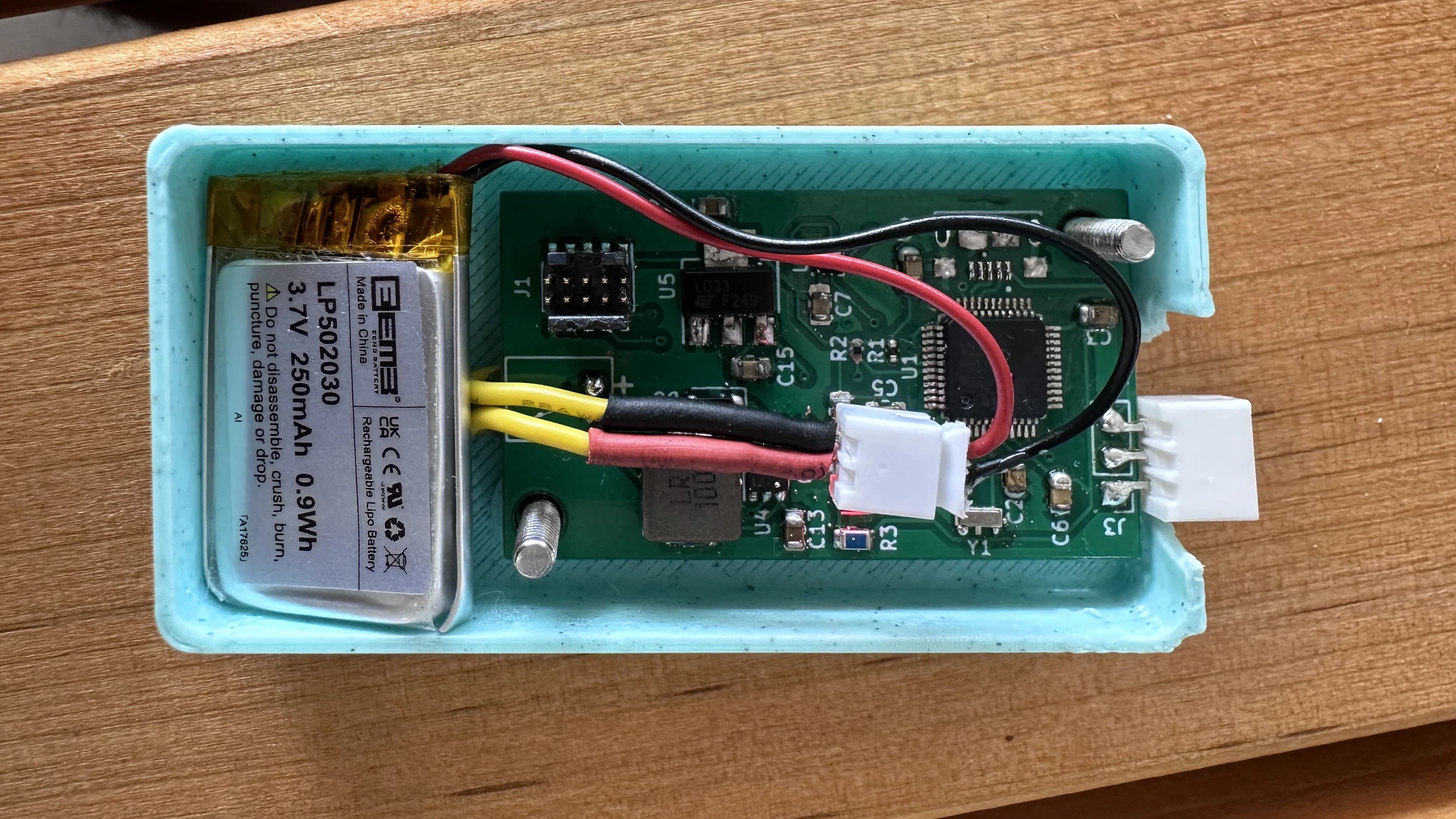 Top view of compact wearable skydiving altimeter PCB showing STM32 microcontroller, barometric pressure sensor, WS2813 addressable LED array, USB interface, and power management circuitry