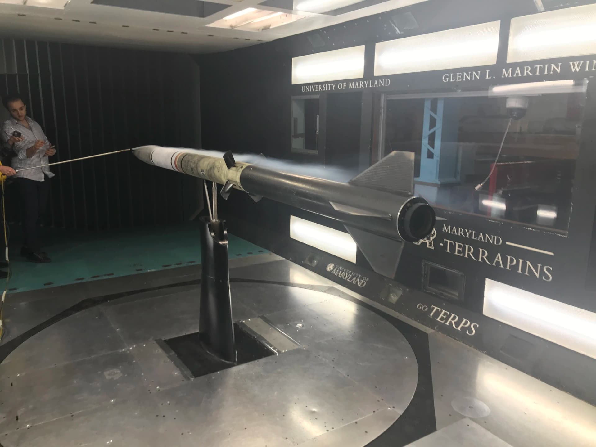 Wind tunnel smoke visualization with airbrake at moderate deployment angle