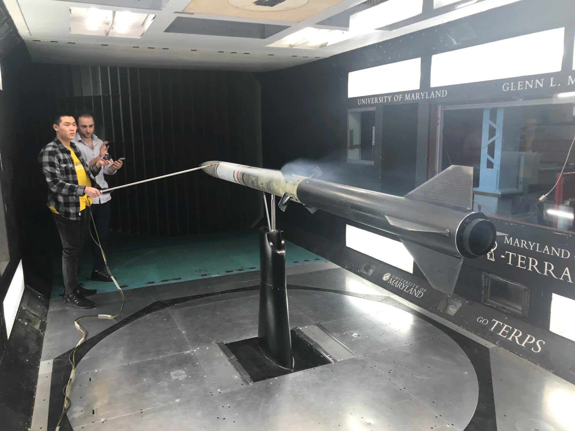 Wind tunnel testing showing smoke flow visualization process