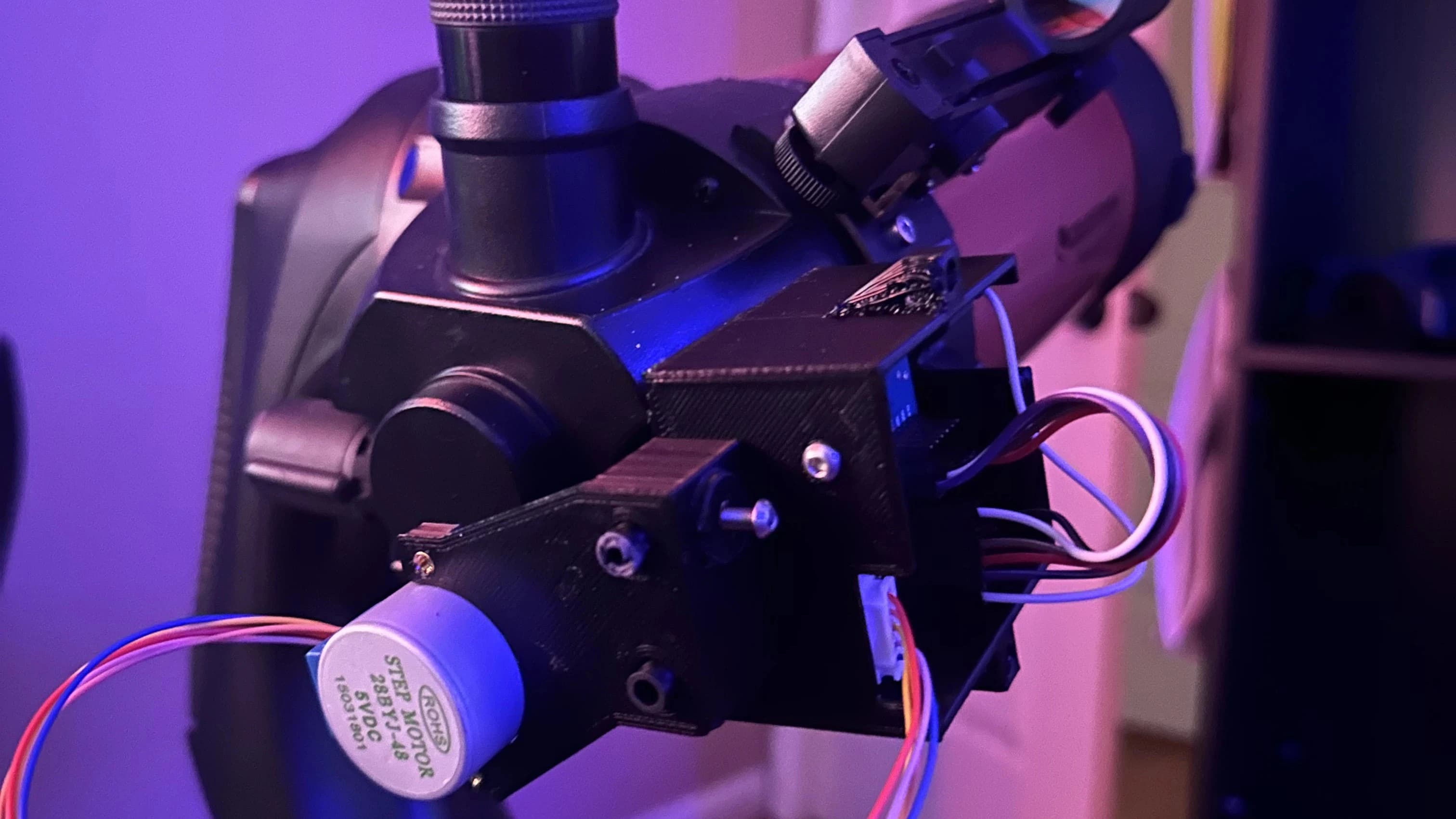 Motorized telescope focuser mechanism with stepper motor assembly, gear reduction system, and STM32-based control electronics for precise focus adjustment during astrophotography